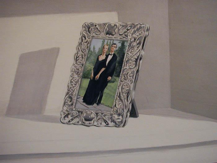 [family photographs in silver frames]